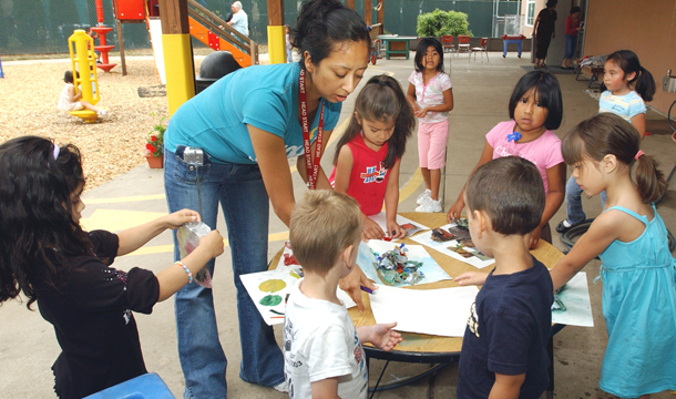 Teacher Margarita Hernandez leads a group of preschoolers with an outdoor art project at a Head Start program in Hillsboro, Oregon. We receive $13 in social benefits for every $1 invested in early childhood education and development, studies show. (AP/Greg Wahl-Stephens)