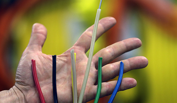 An engineer displays wires that run inside a 1,000-meter cable to be used as a tether to an undersea observatory at the Applied Physics Lab at the University of Washington in Seattle in the May 7, 2013 photo. The multi-million dollar project is paid for by the National Science Foundation. (AP/Elaine Thompson)