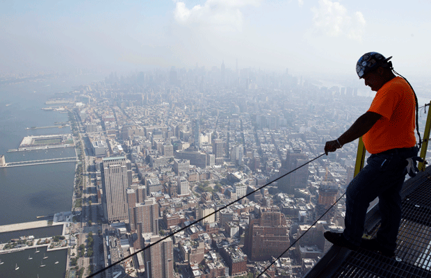 A construction worker takes in the view from the communication rings on top of One World Trade Center in New York. (AP/Seth Wenig)