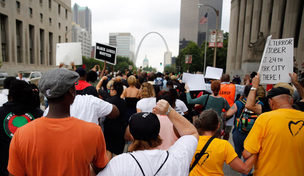 Protesters march to the Thomas F. Eagleton Federal Courthouse on August 10, 2015, in St. Louis, Missouri. (AP)