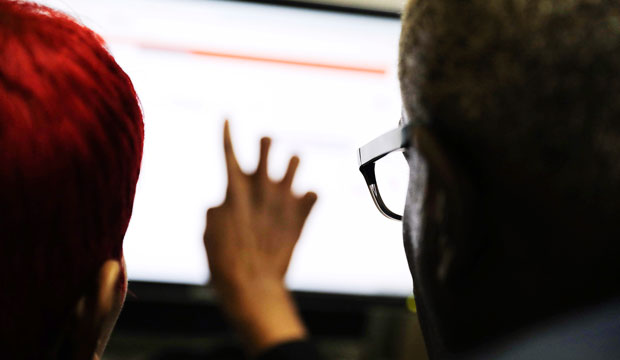 A Georgia Department of Labor services specialist helps a woman with a job search at an unemployment office in Atlanta on March 3, 2016. (AP/David Goldman)