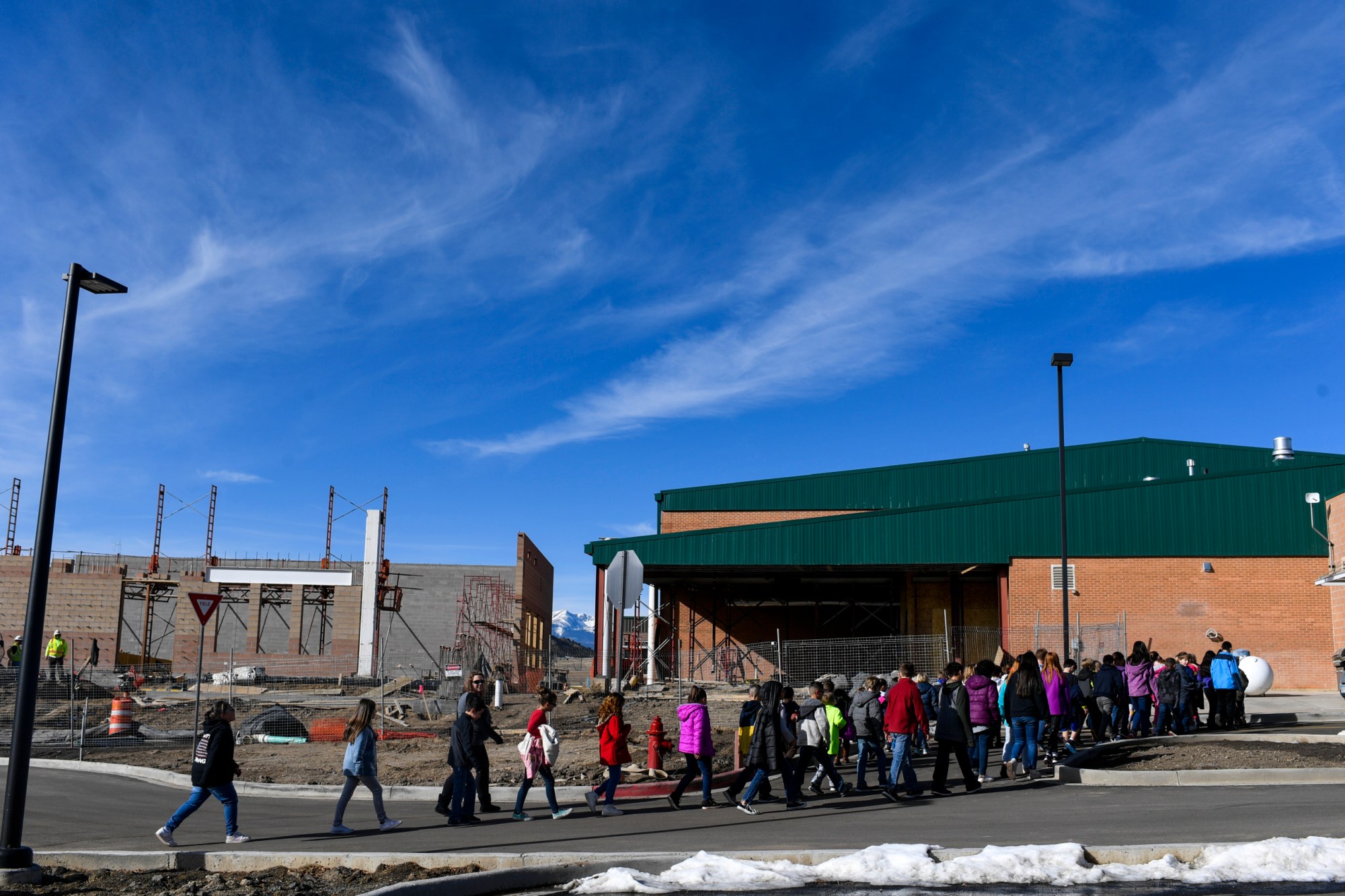 Students walk back to class as construction crews work on the wellness center and gymnasium additions at Primero school in Weston, CO. (Getty/AAron Ontiveroz)