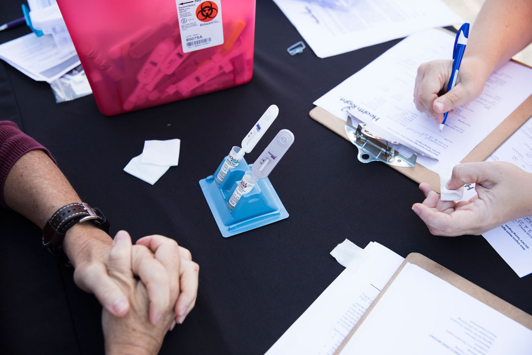A patient fills out a form while her blood and saliva are screened for hepatitis C and HIV in the rural town of Spencer, West Virginia, September 2017. (Getty/The Washington Post/Philip Scott Andrews)