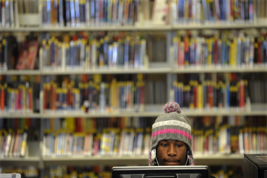 A community college student works at a computer in the library. (Getty/Kathryn Scott Osler)