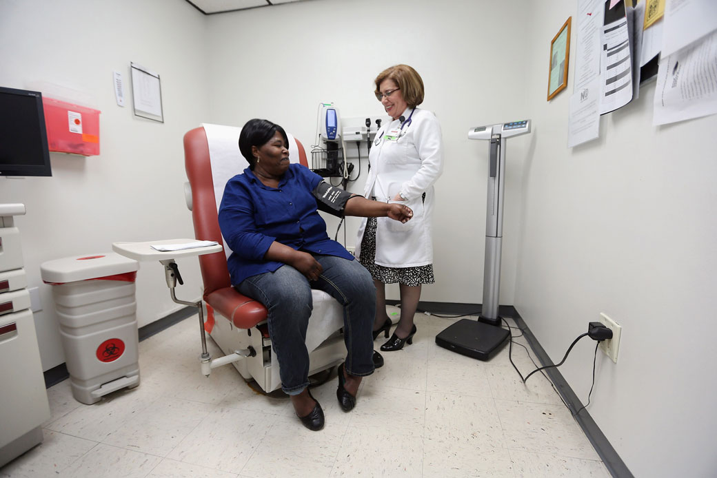 A doctor examines a patient on February 21, 2013, in Miami, Florida. (Getty/Joe Raedle)