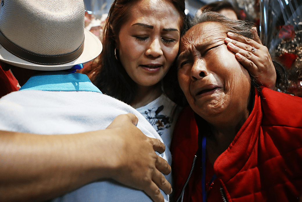 Family members hug at a reunification event for Mexican families who have been separated from their loved ones living in the United States, Los Angeles, September 2018. (Getty/Mario Tama)