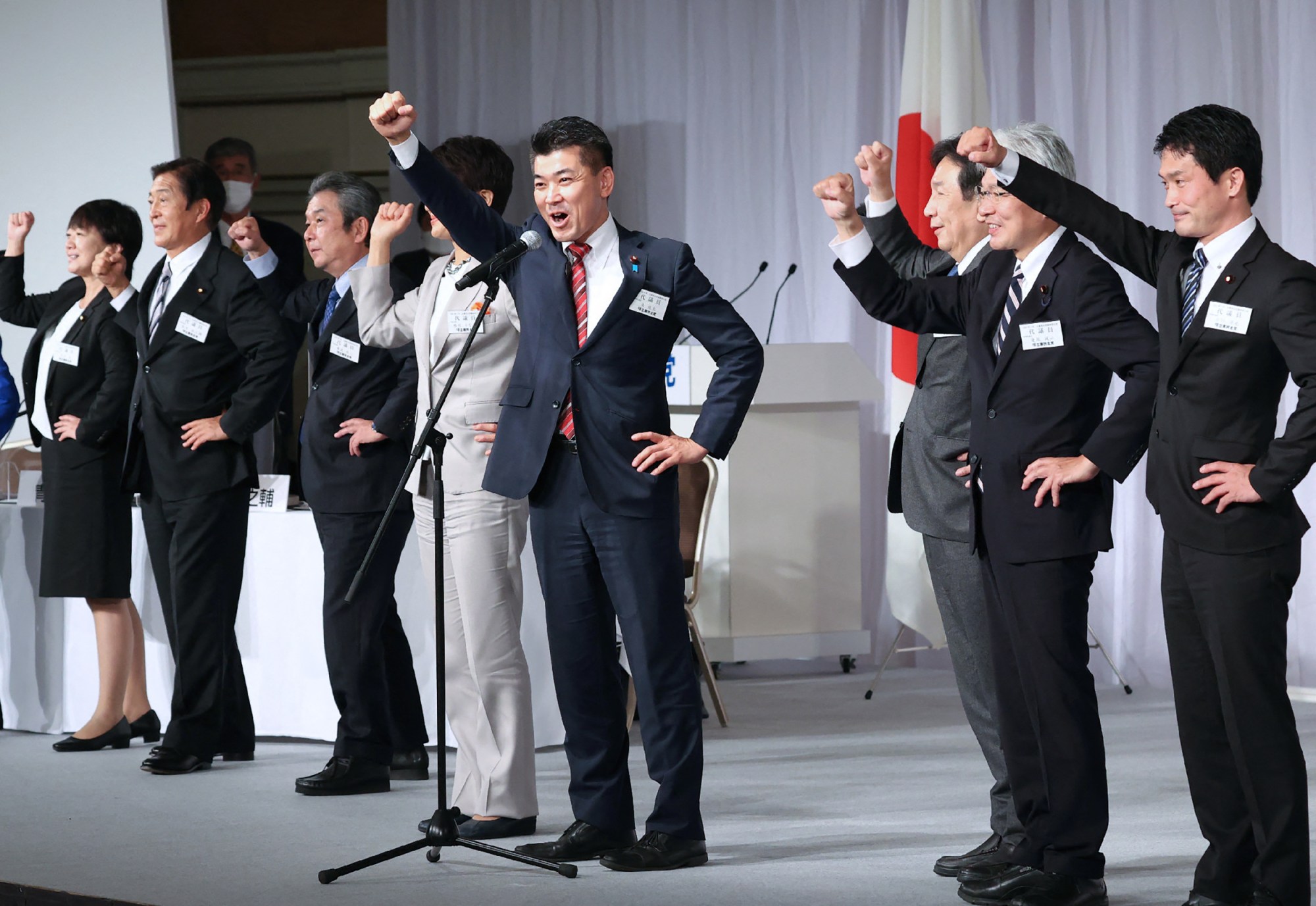 Kenta Izumi (C) reacts with party members after he was elected as the new leader of the main opposition Constitutional Democratic Party of Japan in a party vote during the party's extraordinary convention in Tokyo on November 30, 2021. - - Japan OUT (Photo by JIJI PRESS / AFP) / Japan OUT (Photo by STR/JIJI PRESS/AFP via Getty Images)