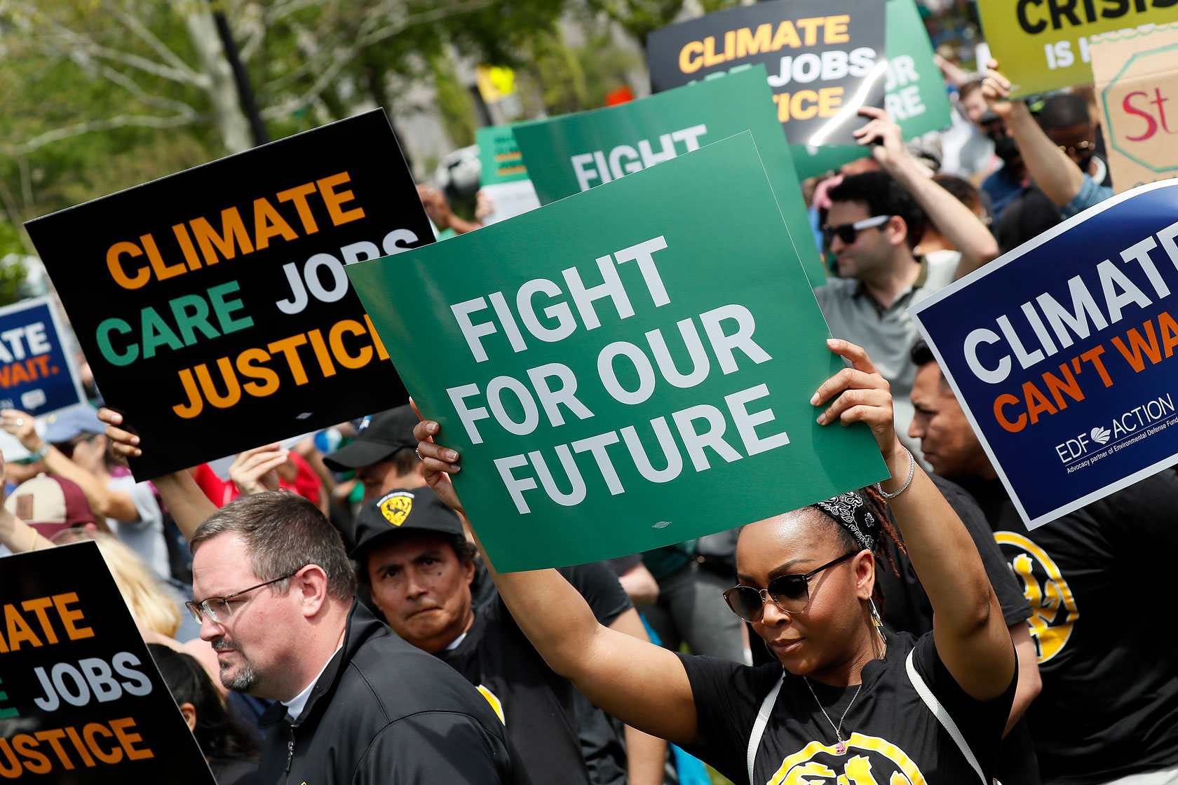 Activists hold up signs during the 