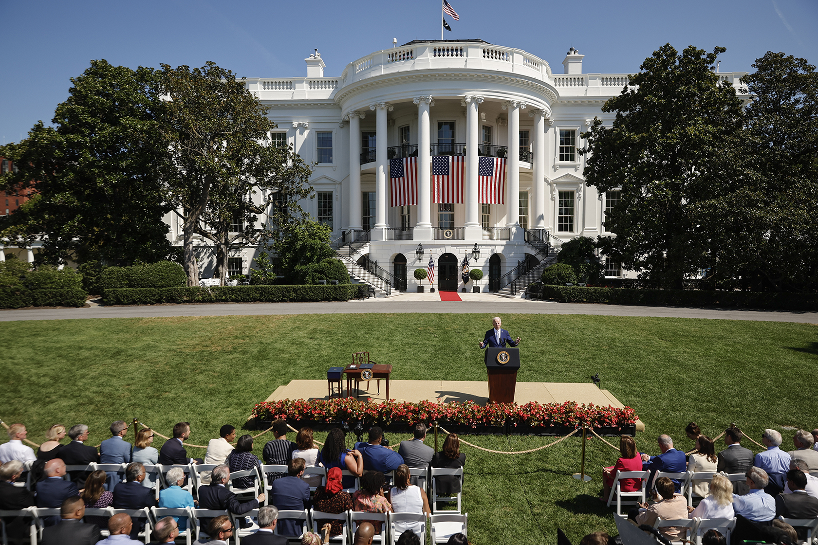 Biden in front of crowd with White House in background