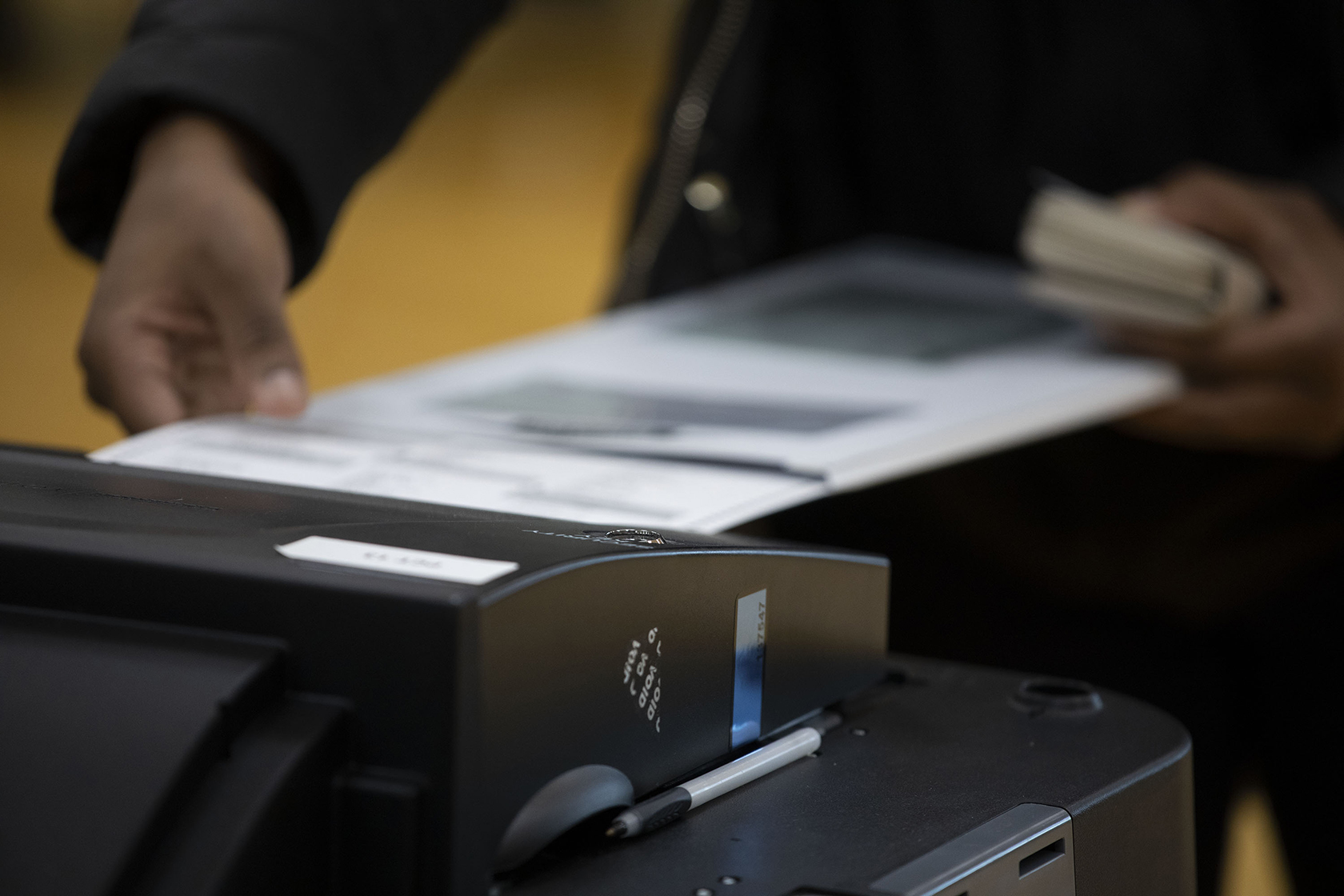 Close-up of hand casting vote
