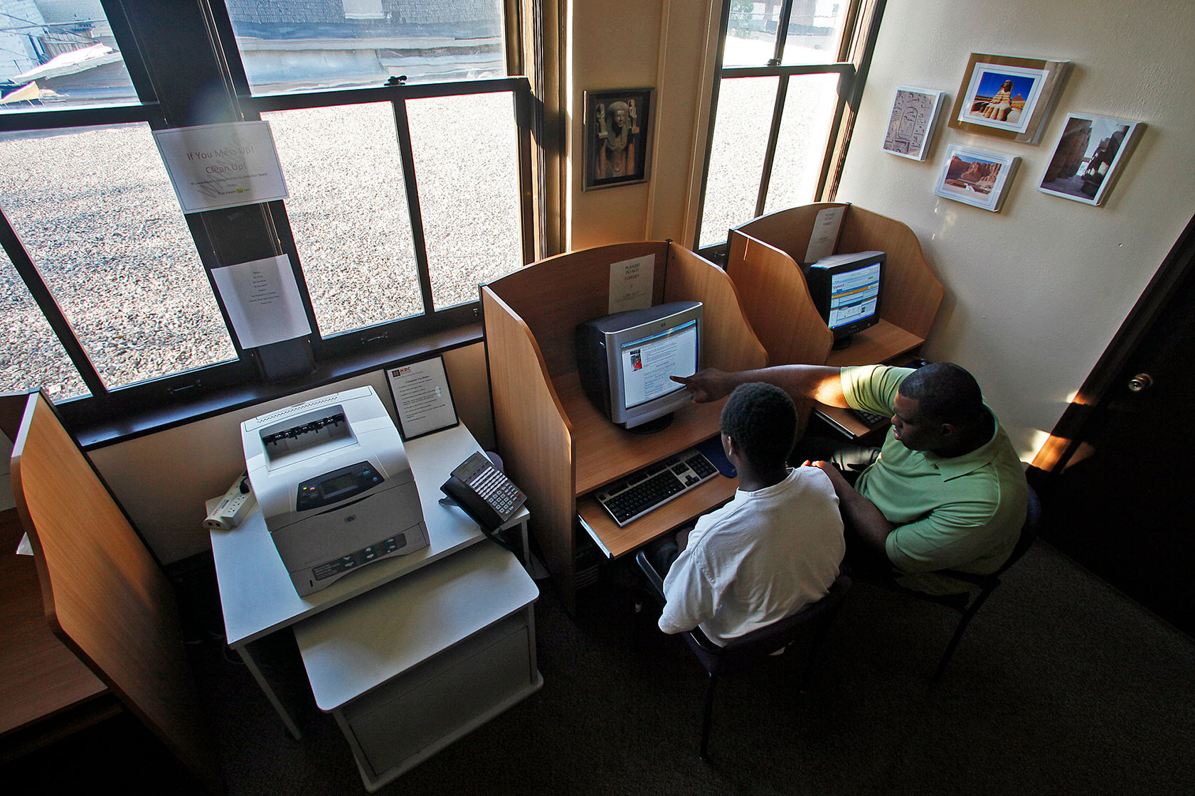 A social service worker helps justice-involved youth look for employment.