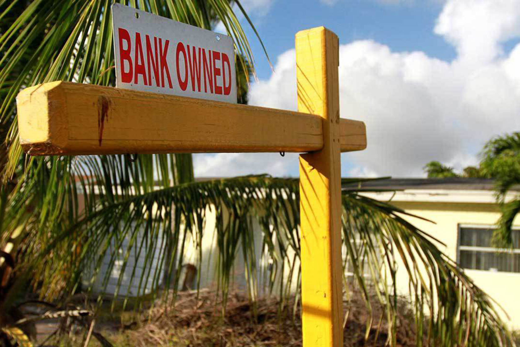 Photo shows a yellow sign post holding a sign that says 