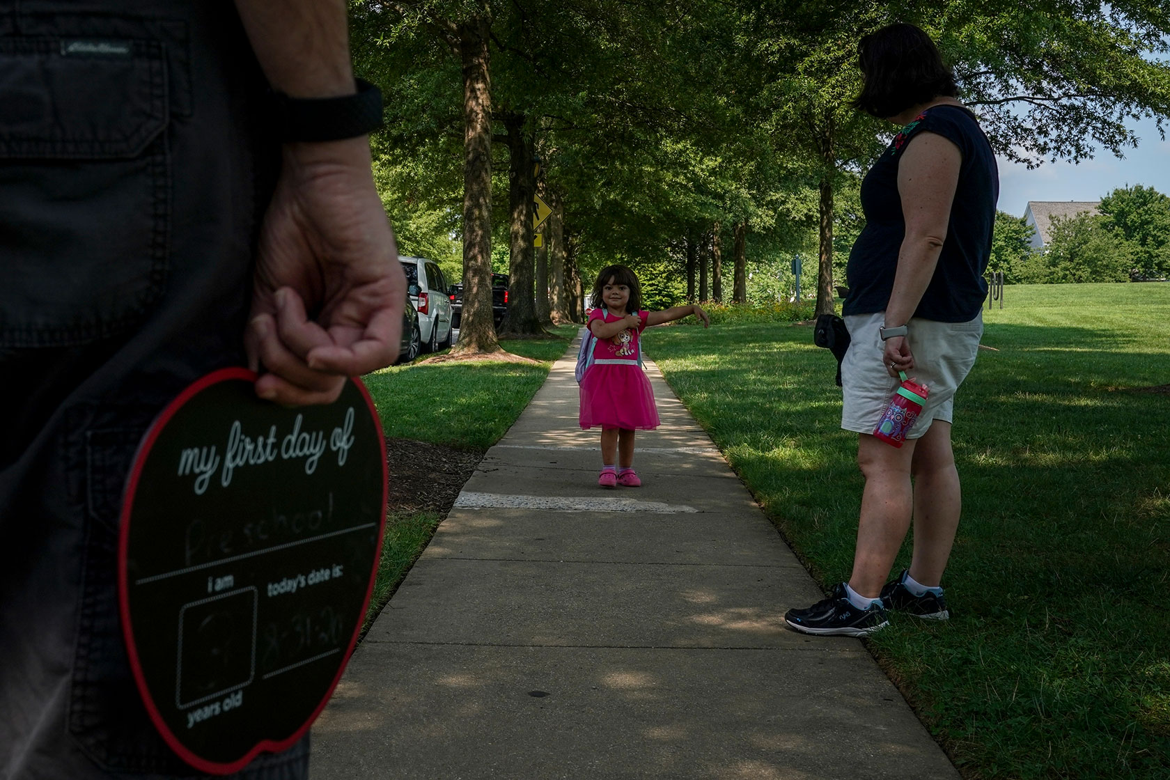A 3-year-old walks to a park with her family in Rockville, Maryland.